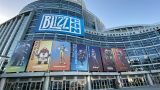 A picture of the outside of Blizzcon, Blizzard's convention. There are prominently features images of Blizzard properties, like Hearthstone, Overwatch and more.
