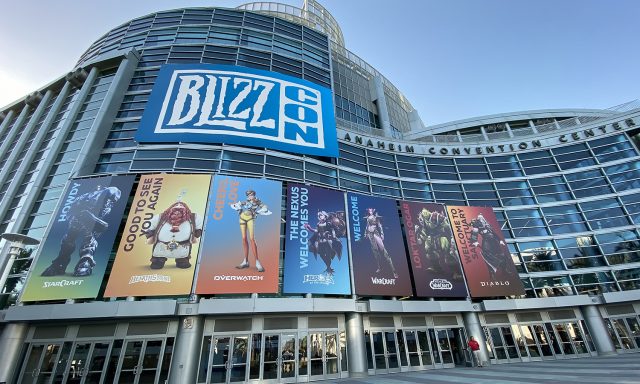 A picture of the outside of Blizzcon, Blizzard's convention. There are prominently features images of Blizzard properties, like Hearthstone, Overwatch and more.